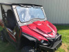 Extreme Metal Products laminated glass windshield with wiper on a red Yamaha Wolverine X2, front three-quarter view