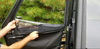 Hand opening the zip-down window on the Spike Ranger door, close-up of the zipper and window panel