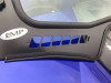 Close-up of the EMP badge and slotted vent openings on the black lower frame of the YXZ glass windshield