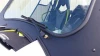 Close-up of the Extreme Metal Products windshield frame corner and wiper arm mount below the Maverick roof edge