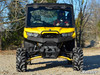 Front view of a yellow Can-Am Defender with the SuperATV diamond plate front bumper and winch fairlead