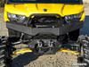 Straight-on front view of the SuperATV diamond plate bumper with shackle mounts on a yellow Can-Am Defender