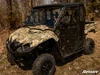 Front three-quarter view of the camo Yamaha Viking with the SuperATV cab enclosure hard doors in a dry field