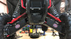 Front view of a Honda Talon 1000X on a lift with Trail Armor iMpact front arm guards on both lower A-arms
