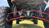 Rear underside view of a Honda Talon 1000 X showing the red trailing arms with Trail Armor guards fitted, on grass