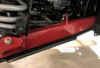 Side view of the Trail Armor guard running the full length under the red trailing arm of a Honda Talon 1000 X