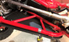 Trail Armor arm guard fastened under the red front A-arm of a Honda Talon 1000R, seen from below the wheel