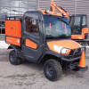 Wiedmann Bros Challenger utility bed cap with side tool boxes installed on an orange Kubota RTV X-Series with cab, side view
