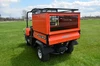 Wiedmann Bros orange 24-inch bed cap with tinted glass rear door and roof rack on an orange Kubota RTV 900/1100, rear view