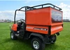 Side view of the Wiedmann Bros bed cap and roof rack over the bed of the Kubota RTV 900/1100 on a grass field