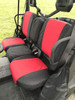 Greene Mountain Can-Am Defender seat covers in red and black, angled view of the bench and door net