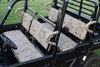 Greene Mountain camo seat covers on the front and rear bench seats of a black Kawasaki Mule Pro FXT, side view