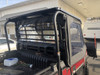 Greene Mountain black soft door on a red Kawasaki Mule ProFX, rear quarter view from the cargo bed