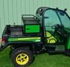 Side view of the John Deere Gator with the Wiedmann Bros crossover cabinet mounted at the front of the bed