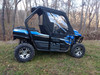 Side X Side upper doors kit with clear windows on a blue Kawasaki Teryx 2 in the woods, side view