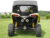 3 Star soft back panel with clear window installed on a yellow CanAm Maverick, rear view in a field