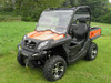 Front three-quarter view of an orange CF Moto UForce with the 3 Star 2-piece windshield installed on grass