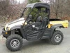 Full side view of a yellow Cub Cadet Challenger 500 with the 3 Star soft top fitted, parked on pavement