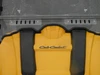 Close-up of the 3 Star 2-piece windshield lower edge with vent slots on a yellow Cub Cadet Challenger hood