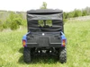 Rear view of the 3 Star cab enclosure rear window panel above the cargo bed of a blue side-by-side on grass