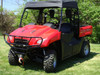 3 Star black soft top installed on the roll cage of a red Honda Big Red, front three-quarter view on grass