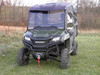 3 Star two-piece windshield on a green Honda Pioneer 700-4 with full soft cab enclosure, front view in a field