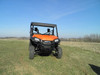 Front view of an orange Honda Pioneer 1000 with the 3 Star soft top installed on grass