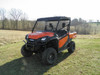 Orange Honda Pioneer 1000 with a 3 Star black soft top, front three-quarter view in a field with no doors installed