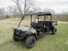 Driver side front three-quarter view of the camo John Deere Gator XUV-4 wearing the 3 Star black soft top