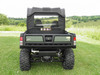 Straight rear view of a green John Deere Gator on grass with the 3 Star soft back panel and clear window behind the seats