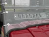 Close-up of the 3 Star windshield vent slots, clamp knobs and rubber edge over a red hood
