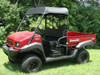 Front three-quarter view of a red Kawasaki Mule with the 3 Star soft top on the roll cage