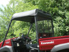 Close-up of the 3 Star soft top over the cab of a red Kawasaki Mule from the passenger side