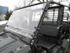 Side angle of the 3 Star 2-piece windshield on a Kawasaki Mule ProFX showing the cage clamps and cab interior