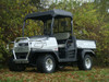 White Kubota RTV900 with the 3 Star black soft top installed, front three-quarter view on grass with fall trees