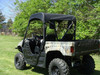 Rear three-quarter view of the camo Yamaha Rhino with the 3 Star soft top and cargo bed