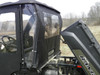 3 Star soft door with clear window on a side-by-side with the cargo bed tilted up, driver side close-up