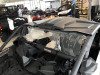 Extreme Metal Products clear rear window dust stopper behind the seats of a Can-Am Maverick X3 in a showroom, side view