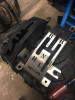 Extreme Metal Products Maverick X3 shifter gate plate on the removed console piece in a shop, showing the cut-out pattern
