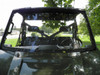 Straight front view of the 3 Star two-piece windshield showing the hinge line and mirrors on the green Polaris Ranger
