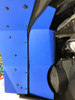 Blue color option of the Trail Armor fender extension installed beside a headlight, close-up portrait crop
