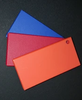 Trail Armor color options: blue, red and orange plastic swatches fanned out on a black background