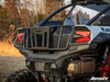 Rear three-quarter view of the SuperATV bed enclosure on a white Kawasaki Teryx KRX 1000 with exhaust and taillight