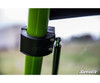 Close-up of the SuperATV flip windshield clamp and gas strut mount on the green cage tube of a Textron Wildcat XX
