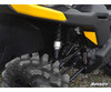 Close-up of the front shock and SuperATV lift spacer under the yellow front fender of a Can-Am Defender