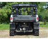 Rear view of a silver Yamaha Viking with the SuperATV 2-inch lift kit and mud tires on a gravel trail