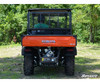 Rear view of an orange Kubota RTV X Series lifted with the SuperATV 2 inch kit, showing the rear suspension