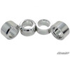 Four machined aluminum shock spacers from the SuperATV Can-Am Maverick Trail 3-inch lift kit on white