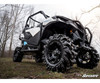 Low angle rear corner close-up of the lifted Can-Am Maverick Trail showing the mud tire and SuperATV lift