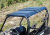 SuperATV black hard plastic roof installed on the roll cage of a camo Bobcat 3400, angled view from above